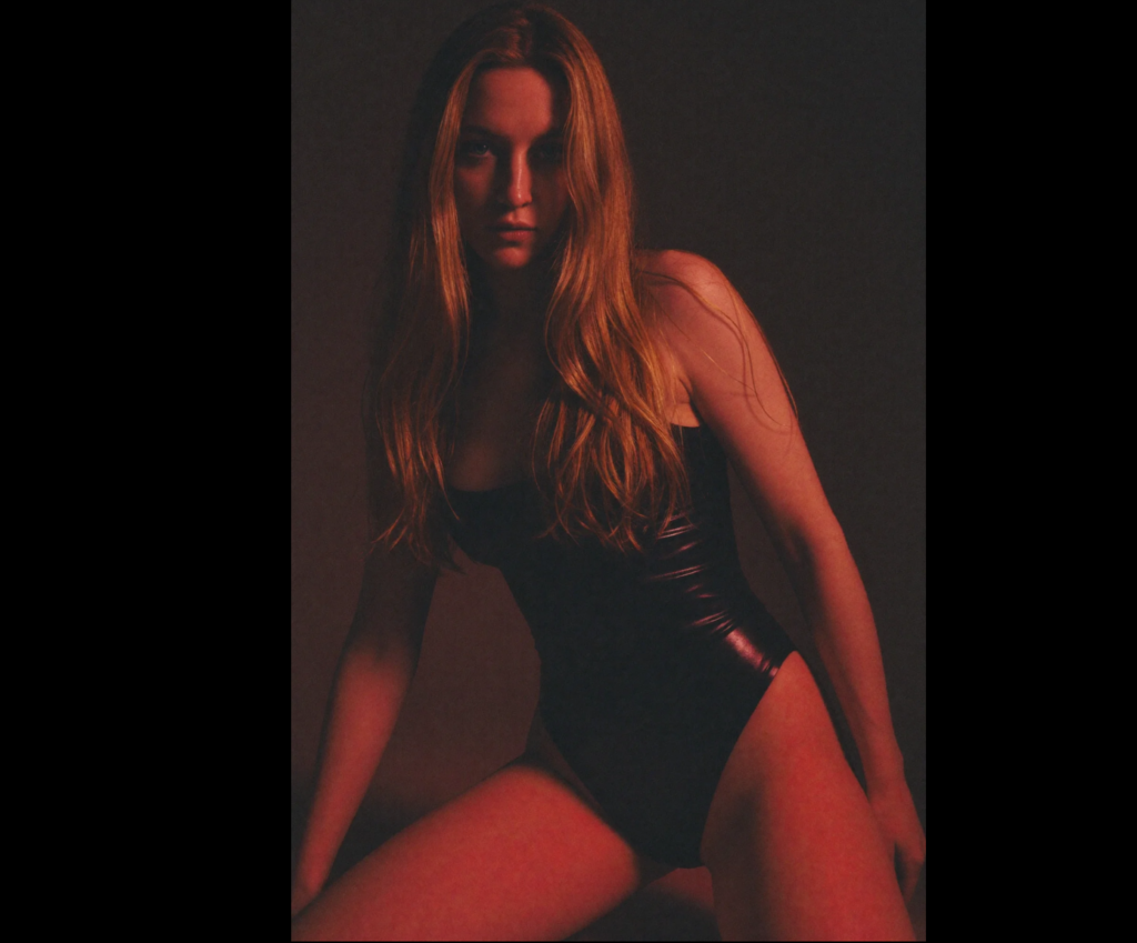 Ukrainian VR cam girl in moody studio photo.